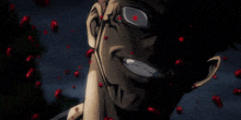 a close up of a person 's face with red eyes and blood coming out of his mouth .