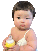 a baby is holding a yellow bottle with a nipple .