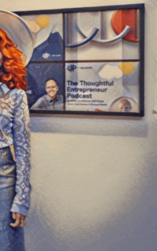 a woman with red hair is standing in front of a sign that says the thoughtful entrepreneur podcast