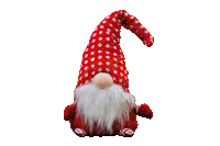 a stuffed gnome with a polka dot hat and beard