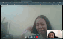 a screenshot of a video call between a woman and a child