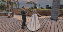 a bride and groom are standing on a wooden deck