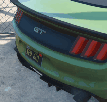 a green gt car with a license plate that says xeo 640