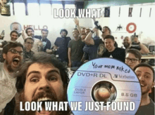 a group of men are posing with a dvd that says your mom naked