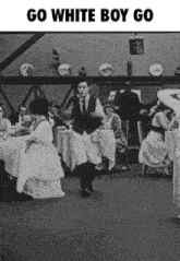 a black and white photo of a man dancing in a room with the words go white boy go on the bottom