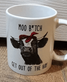 a mug with a cow on it that says moo bitch get out of the hay