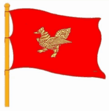 a red flag with a gold bird on it is waving in the wind on a yellow pole .