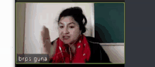 a woman wearing headphones and a red scarf is on a video call with the name brps guna on the bottom