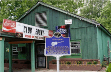 a building with a sign that says " club ebony " on it