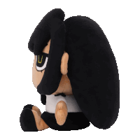 a stuffed animal with black hair and a white shirt has the letter u on its face