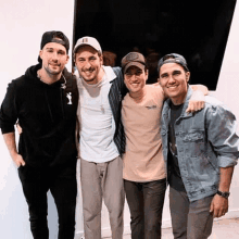 a group of young men are posing for a picture together and smiling .