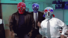 a group of men wearing masks are standing in an office .