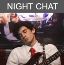 a man in a white shirt and red tie is playing a guitar with the words night chat above him