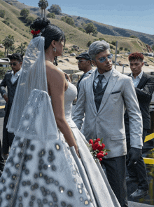 a bride and groom are standing next to each other with their wedding party