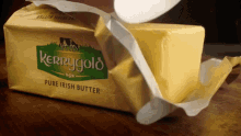 a package of kerrygold pure irish butter is being opened