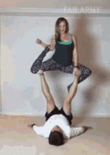 a woman is holding a man 's legs up in the air with failarmy written on the bottom