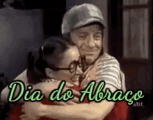 a man and a woman are hugging each other with the words dia do abraço written on the bottom .