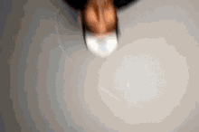 a blurred image of a person 's face with a white mask on .