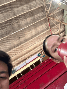 a man and a woman are posing for a picture with a red cup in front of them