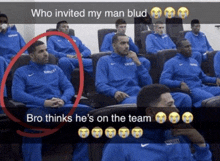 a group of men in blue sweatshirts are sitting in a room and one of them is named blud