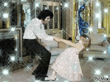 a man and a little girl are dancing in a living room with picmix written in the corner