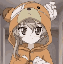 a girl is wearing a teddy bear costume with a bandage on her arm .