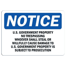 a blue and white sign that says notice u.s. government property no trespassing whoever shall steal or willfully cause damage