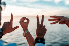 a man and woman making the word love with their fingers