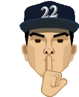 a baseball player with the number 22 on his hat holds his finger to his mouth