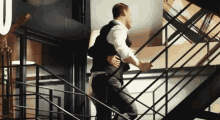 a man is carrying another man up a set of stairs