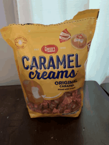 a bag of caramel creams is sitting on a table