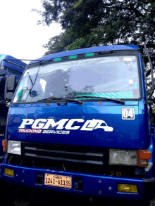 a blue truck that says pgmclr trucking services