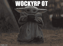 a baby yoda holding a cup with the words wockyrp ot on it