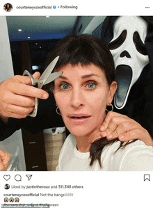 a woman with a scream mask is getting her hair cut