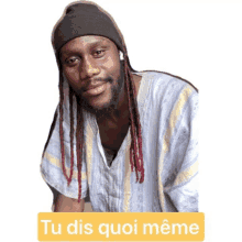 a man with dreadlocks and a beanie has a sticker that says tu dis quoi meme