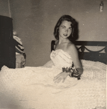 a black and white photo of a woman in a wedding dress