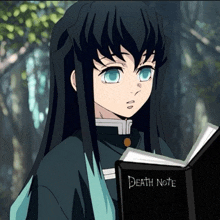 a boy with long black hair is reading a death note book