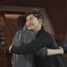 two young men hugging each other and one is smiling