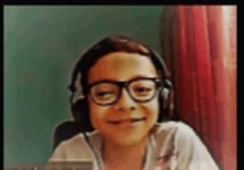 a young girl wearing glasses and headphones is smiling at the camera