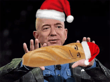 a man wearing a santa hat is holding a bread