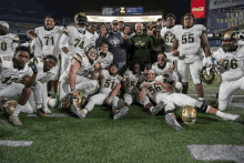 a group of football players are posing for a picture and one of them is wearing the number 55