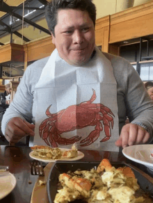 a man is wearing a bib with a crab on it