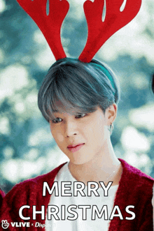 a man wearing a reindeer headband says merry christmas on the bottom