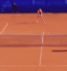 a man is swinging a tennis racket at a tennis ball on a court with a sign behind him that says provincia di corba