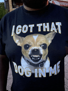 a man is wearing a black t-shirt with a picture of a dog and the words " i got that dog in me "