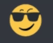 a yellow smiley face wearing black sunglasses on a dark background