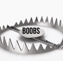 a metal trap with a tag that says boobs