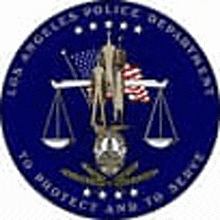 the seal of the los angeles police department is a blue circle with a scale of justice and an american flag on it .