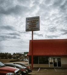 a building with a red roof and a sign that says auto title loans and payday loans