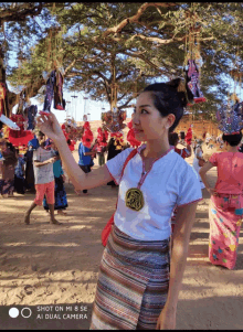 a woman taking a picture with a mi 8 se camera